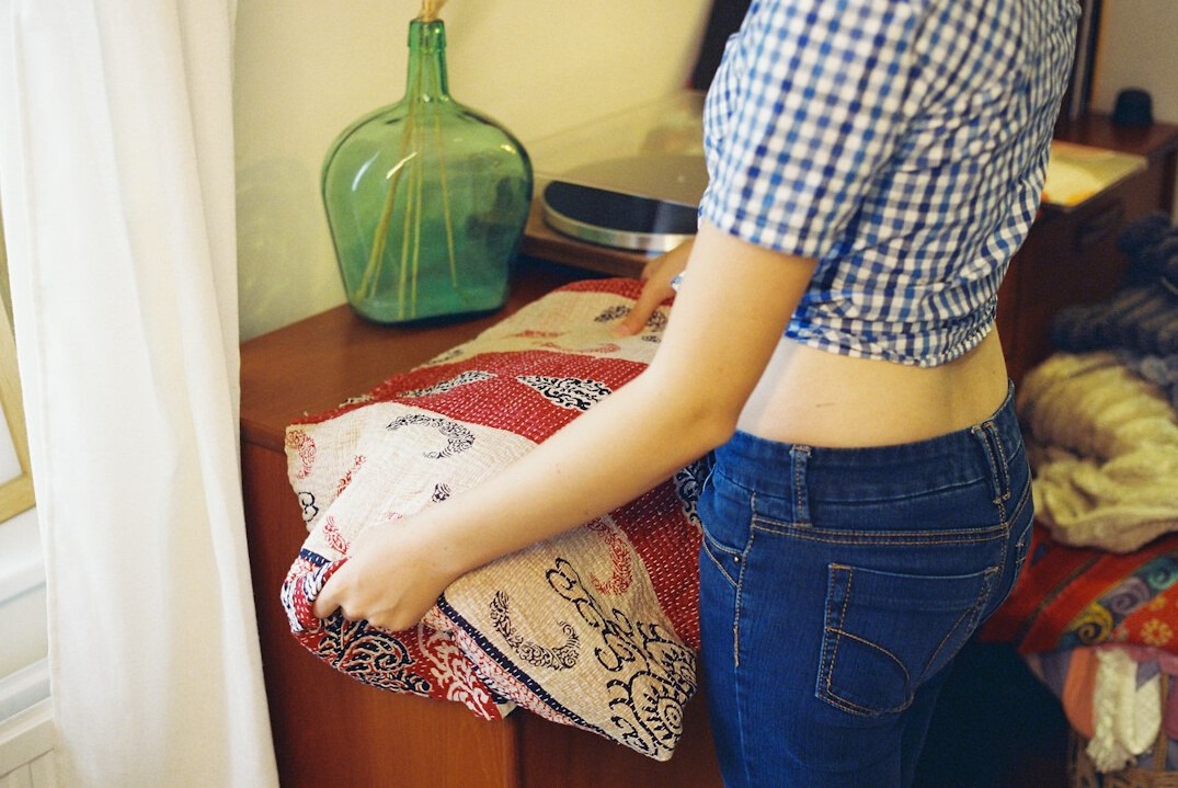 making bed in bedroom